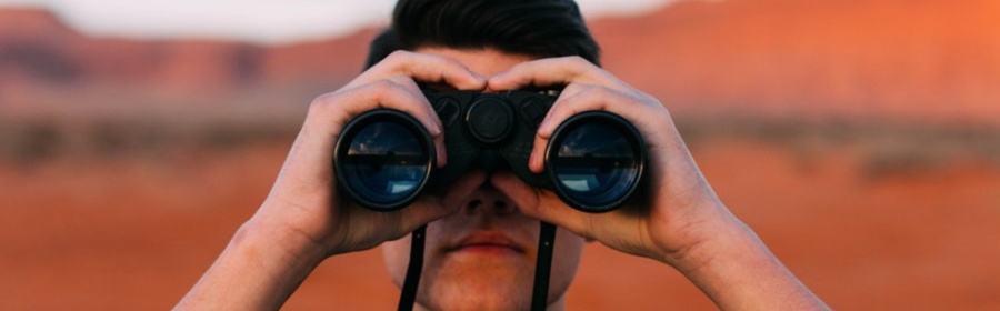 man using binoculars